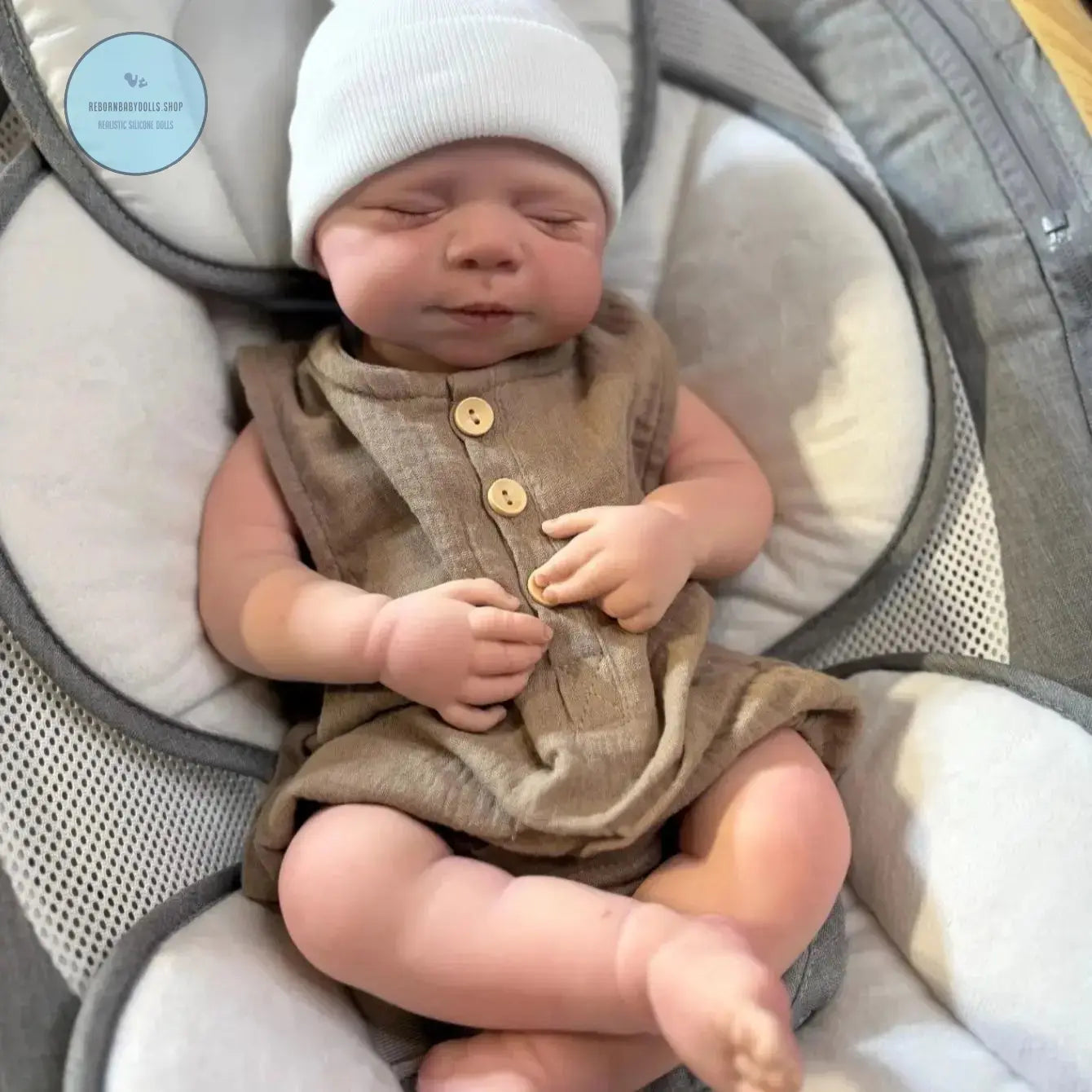 Realistic reborn baby boy doll with soft silicone body in baby outfit
