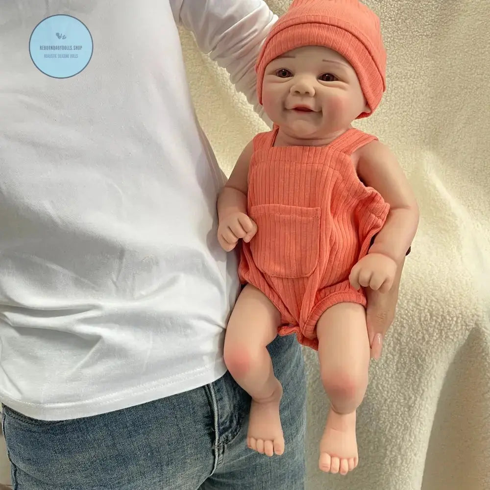 Reborn baby doll with drink and wet feature, holding bottle and wearing diaper